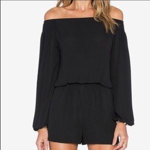 Black off the shoulder long sleeve romper.